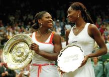 Venus Williams and Serena Williams holding their trophies at Wimbledon 2003.jpg