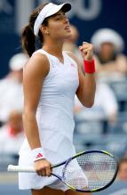 Ana Ivanovic in white dress celebrates a point.JPG