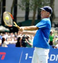 John McEnroe hits a forehand at the 2009 US OPEN experience.JPG