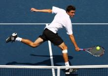Gilles Simon hits a backhand volley.JPG