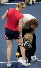 Kim Clijsters' daughter holds on to mommy.JPG