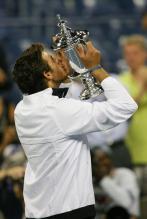 Juan Martin Del Potro kisses his US Open Chamionship trophy.JPG