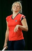 Kim Clijsters smiles holding a racket during a media session.JPG