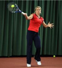 Kim Clijsters demonstrates hitting a high forehand.JPG