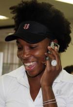 Venus Williams smiles as she talks on her cellphone and displays a big diamond engagement ring.JPG