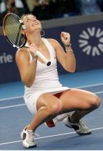 Timea Bacsinszky bends down and looks to the sky in celebration.JPG