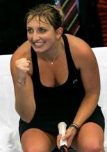 Timea Bacsinszky smiles and celebrates a point sitting down.JPG