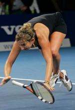 Timea Bacsinszky falls to the ground in a black tennis dress.JPG