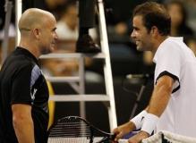 Pete Sampras talks to Andre Agassi across the net.JPG