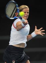 Kim Clijsters hits a high ball driving forehand.JPG