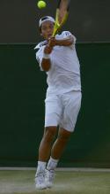 Yen Hsun Lu goes up in the air to hit a high two handed backhand during Wimbledon.JPG