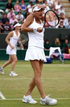 Anna Kournikova puts her hand to her visor during her Wimbledon 2010 doubles match.JPG