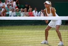 Anna Kournikova plays the net during her Wimbledon 2010 doubles match.JPG