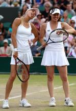 Anna Kournikova sticks out her tongue next to her doubles partner Martina Hingis during Wimbledon 2010.JPG
