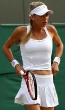 Anna Kournikova adjusts her skirt during her Wimbledon 2010 doubles match.JPG