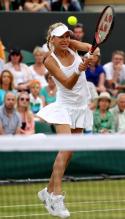 Anna Kournikova hits a high 2 handed backhand during her Wimbledon 2010 doubles match.JPG