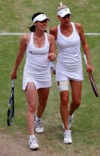 Anna Kournikova and Martina Hingis in doubles action at Wimbledon 2010.JPG