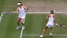 Anna Kournikova rushes to cover the open court as her partner hits the ball.JPG
