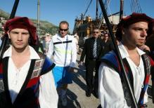 John McEnroe is escorted by guards in costumes at the humanitarian match vs Goran Ivanisevic 2010.JPG