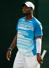 Donald Young in Nike shirt and white shorts and cap looks on.JPG