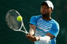 Donald Young with forearm sleeve hits a 2 handed backhand.JPG