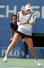 Vera Zvonareva hits a backhand behind the baseline.JPG