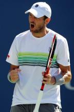 Mardy Fish in a K-Swiss tennis hat and shirt celebrates a point during the US Open 2010.JPG