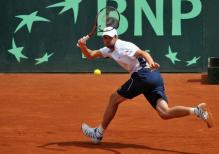 Mardy Fish hits a running defensive forehand on red clay.JPG