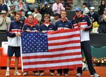 Mardy Fish and Patrick McEntroe and Ryan Harrison and Sam Querrey and John Isner hold the USA Flag as part of the US Davis Cup t