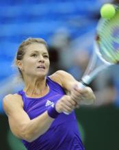 Maria Kirilenko 2 handed backhand on a high ball above her head.JPG