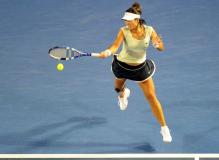 Li Na jumps to hit a forehand at the 2011 Australian Open.JPG