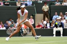 Laura Robson looks to scoop up a low ball with a 2 handed backhand at Wimbledon 2011.JPG