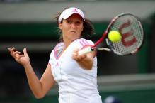 Laura Robson hits a high forehand during 2011 Wimbledon.JPG