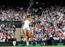 Maria Sharapova hits a difficult overhead at the Wimbledon 2011.JPG