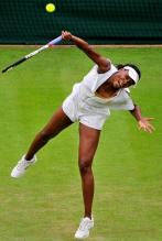 Venus Williams serves the ball in her 2011 Wimbledon Eleven outfit.JPG