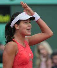 Ana Ivanovic gestures after hitting a shot.jpg