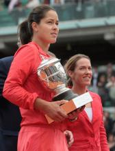 Ana Ivanovic holds the French Open trophy with Justine Henin looking on.jpg