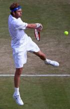 Mardy Fish jumping 2 handed backhand at 2011 Wimbledon.JPG