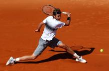 Mardy Fish slides for a slice backhand during 2011 French Open.JPG