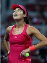 Ana Ivanovic in a fuschia tennis outfit looks up during China Open 2011.JPG