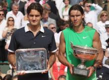 Rafael Nadal holds the French Open trophy while Federer holds the 2nd place trophy.jpg