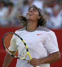 Rafael Nadal reacts after a point during his doubles match.jpg