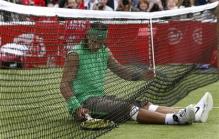 Nadal falls into the net.jpg