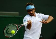 Arnaud Clement hits a forehand.jpg