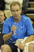 John McEnroe drinks from a bottled watter.jpg