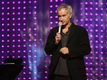 John McEnroe on stage with a mikew.jpg