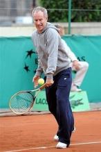 John McEnroe hits a backhand as he hits with Rafael Nadal.jpg