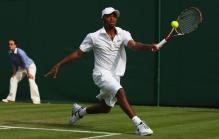 Donald Young hits a forehand slice.jpg