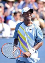 Donald Young smiles after hitting a shot.jpg