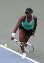 Ahsha Rolle hits a one-handed backhand.jpg